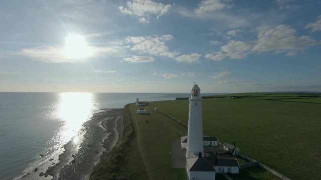 Drone footage filmed at Nash Point lighthouse during a sunset. Would make a great establishing shot