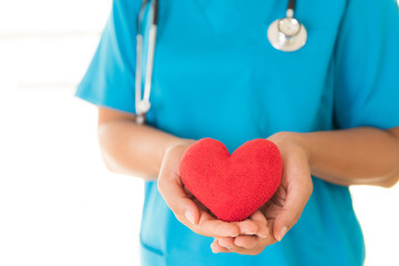 Doctor hands holding red heart. Healthcare And Medical concept.