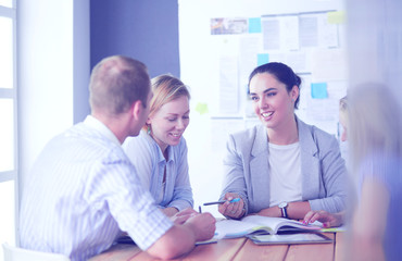 Fototapeta premium Young people studying with books on desk. Beautiful women and men working together.