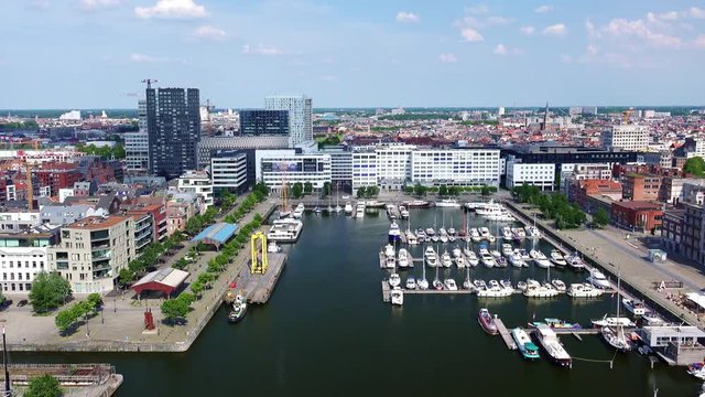 Antwerp amazing panoramic view. European popular touristic city with modern and historical buildings on Scheldt river. Scenery with sail boats, ships and yachts moored to pier. Belgium