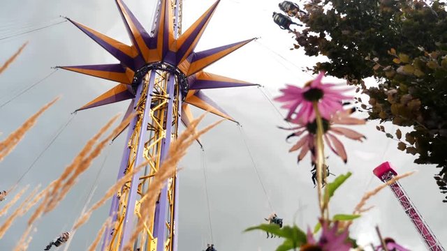 Festival swing chair ride flies riders over midway gardan