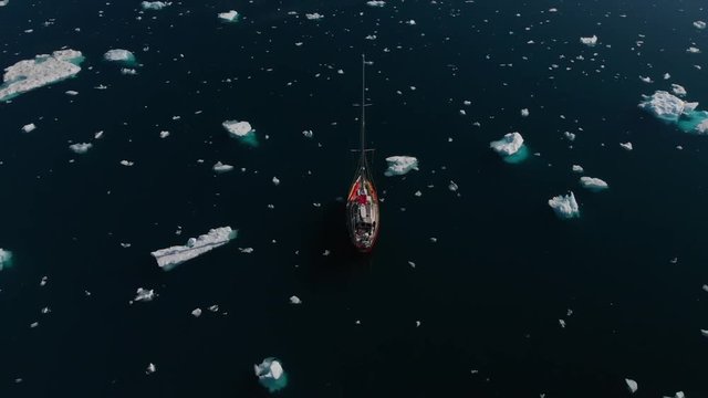 Sailboat Sailing through Icebergs in Johan Petersen Fjord East Greenland