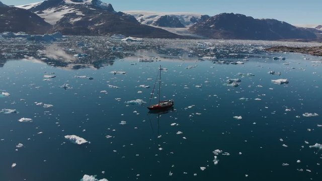 Sailboat Sailing through Icebergs on Johan Peterson Fjord in East Greenland