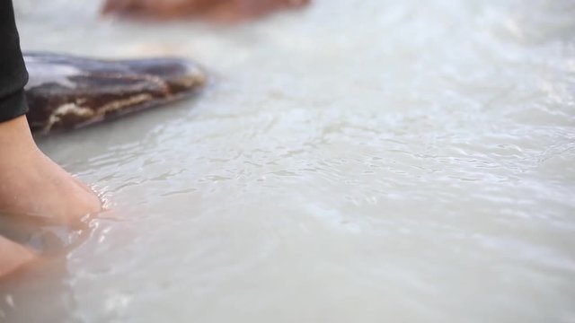 Woman with her feet in the water of Bhaga river, Jispa, Ladakh, Himachal Pradesh, India.
