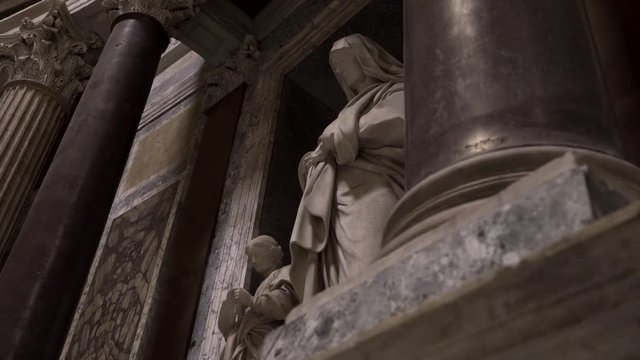 Moving shot showing a satue inside of the Pantheon in Rome, Italy.