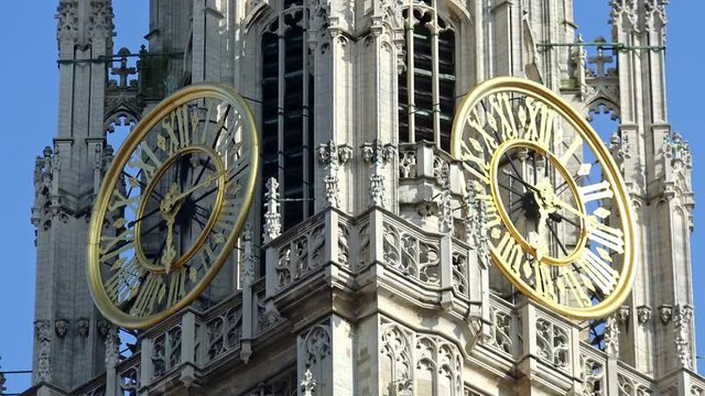 Amazing panoramic view of main tower clock at Cathedral of Our Lady, Antwerp, Belgium. Gorgeous catholic church of exquisite gothic architecture. Beautiful city landmark. Camera zooming out
