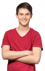 Young man smiling with his arms crossed