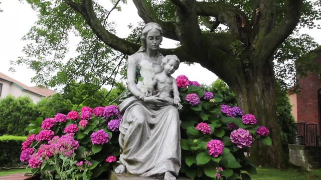 Woman statue holding a child wide dolly in