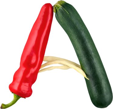 Close-up of vegetable alphabet with red pepper isolated on white
