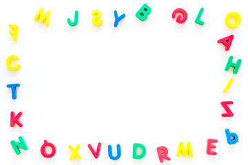 Alphabet for kids concept.  English letters in disorder on white background top view copy space