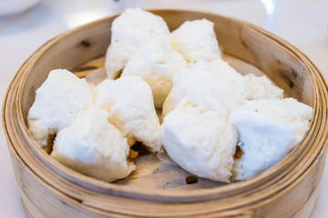 steamed pork buns in dim sum basket
