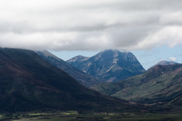 Misty clouds rise over mountain peaks in Waterton Lakes National Park, Canada