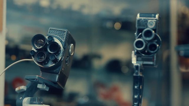 Different variety of Old Vintage cameras are kept in a showcase of a Pawn Shop or Repair shop