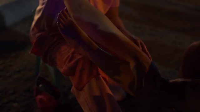 Filipina masseuse does a massage therapy in a public night market in slow motion