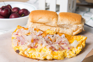 cheese omelette topped with onion and garlic with Filipino pandesal