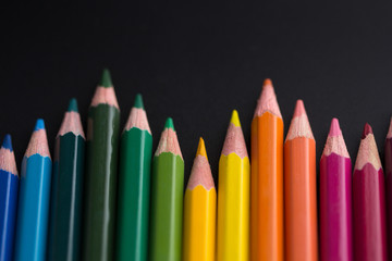color pencils on black background close up..