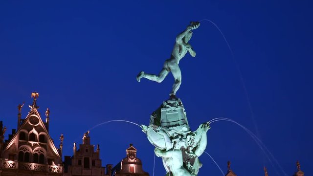 Amazing evening view of guildhalls and Brabo Fountain illuminated by electric light at Grote Markt or Great Market Square, Antwerp, Belgium. Gorgeous landmarks of beautiful old European city at night.