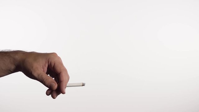 Hand holding cigarette on white background