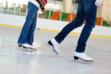 Close-up of Legs in Skates on Skating Rink