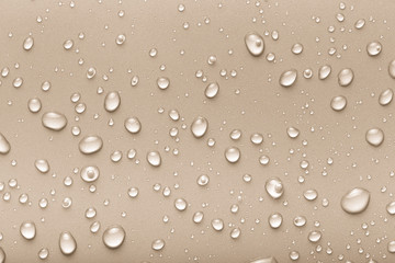 Drops of water on a color background. Beige. Toned