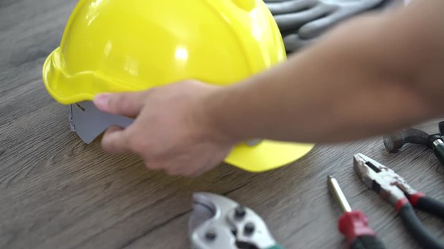 Craftsman tool, for man worker. Man pick up and put down industrial Safety Helmet.
