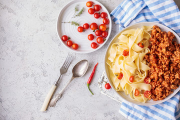 Pappardelle pasta with bolognese sauce and cherry tomatoes