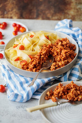 Pappardelle pasta with bolognese sauce and cherry tomatoes