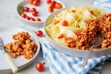 Pappardelle pasta with bolognese sauce and cherry tomatoes