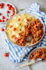 Pappardelle pasta with bolognese sauce and cherry tomatoes