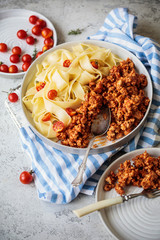 Pappardelle pasta with bolognese sauce and cherry tomatoes