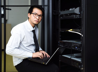 handsome business man engeneer in datacenter server room