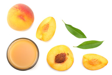 glass of peach juice with peach fruit, green leaf and slices isolated on white background. top view