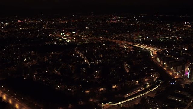 A extremely wide aerial pan from Stockholm city over to the Ericsson Globe at night