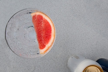 Top down view of cocktail glass with grapefruit in it.