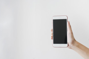 Cropped shot view of Asian woman's hands holding smart phone 