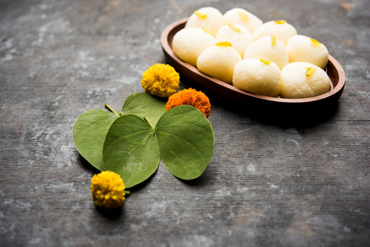 Happy Dussehra / Vijayadashami / Ayudh Puja greeting card using apta/Bauhinia racemosa/Bidi leaf and indian sweet Rasgulla for Navaratri