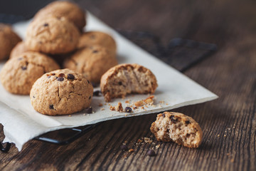 oatmeal cookies with chocolate on a wooden table