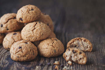 oatmeal cookies with chocolate on a wooden table
