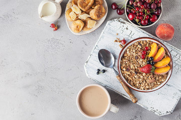 Healthy breakfast with granola and dried fruit, fresh fruit. Cup of coffee with milk