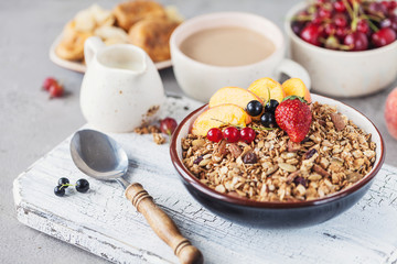 Healthy breakfast with granola and dried fruit, fresh fruit. Cup of coffee with milk