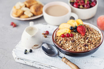 Healthy breakfast with granola and dried fruit, fresh fruit. Cup of coffee with milk