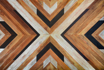seamless yellow, black, white and dark brown color lumber in arrows or chevron pattern to the center for texture background. top view
