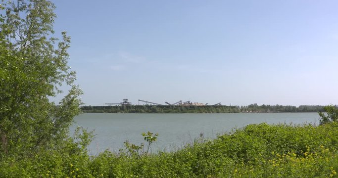 extraction of sand and gravel, creating a lake. Production site at Lingemeer near Echteld, The Netherlands.