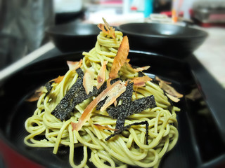 Homemade Zaru Ramen Noodle with dried seaweed and Dried Bonito Katsuo Bushi in black plate / Japanese Food