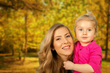 Fototapeta na wymiar Mother and daughter portrait in autumn park