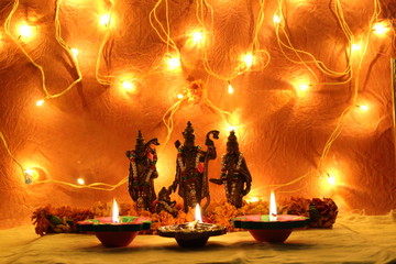 worshiping of hindu god ram and sita on dussehra and diwali festival with oil lamp