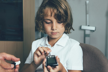 Child using a glucometer