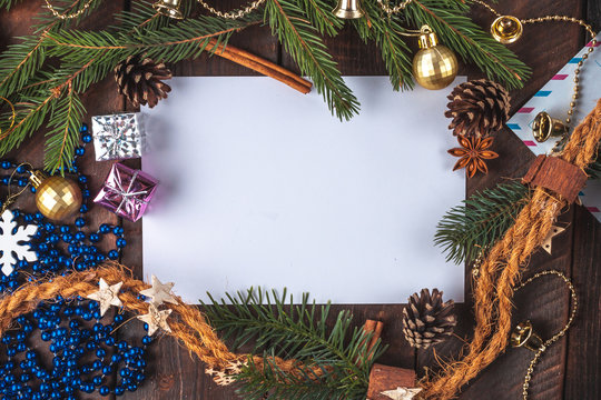 Christmas decorations, balls, anisee tree, cinnamon, cones, spruce branch, gifts on a wooden background. Christmas and New Year holidays. Copy space. Top view. Christmas flat lay and background