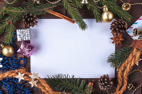 Christmas decorations, balls, anisee tree, cinnamon, cones, spruce branch, gifts on a wooden background. Christmas and New Year holidays. Copy space. Top view. Christmas flat lay and background