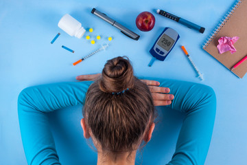 Diabetes. Diabetes concept. Tired of diabetes, high sugar, disease. Diabetic supplies on a blue...